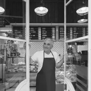 Business owner looking out of shop window 