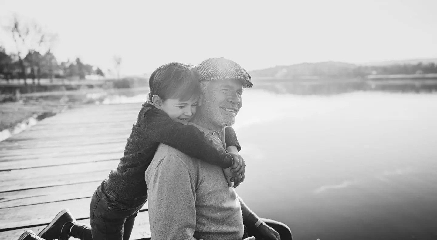 Man and boy sitting on dock