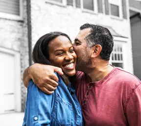 Smiling people kissing