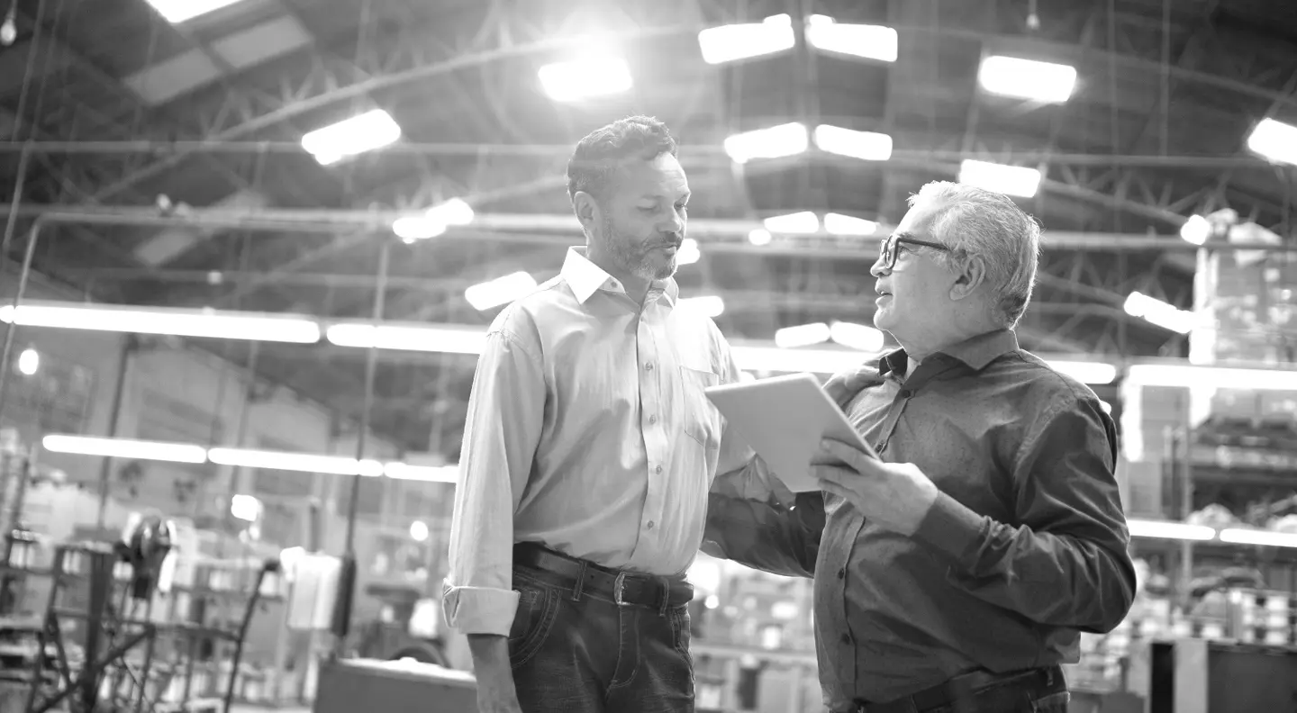 Colleagues talking at factory 