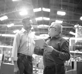 Colleagues talking at factory