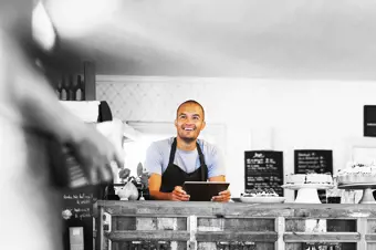 Smiling café owner