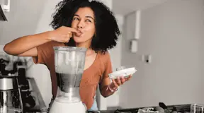 Person enjoying a freshly made smoothie