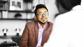 People in a meeting smiling