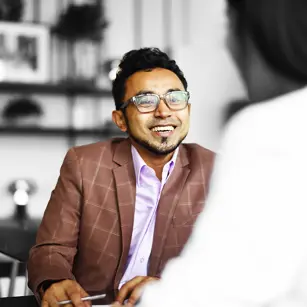 People in a meeting smiling